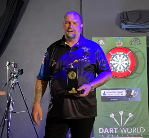Mal Cuming holding a trophy at the 2024 Port Phillip Darts League grand finals